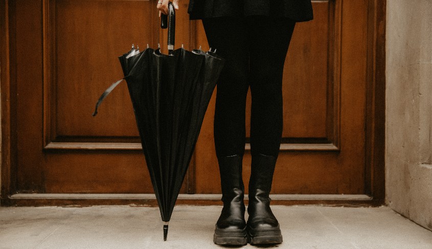 mujer con botas de agua y paraguas